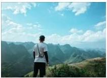 Người đứng trên đồi núi nhìn ra phong cảnh